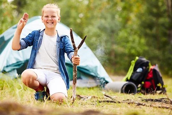Mortgages: Be Prepared! 4 Young boy scout with stick showing open palm and three fingers put together during his backpack trip
